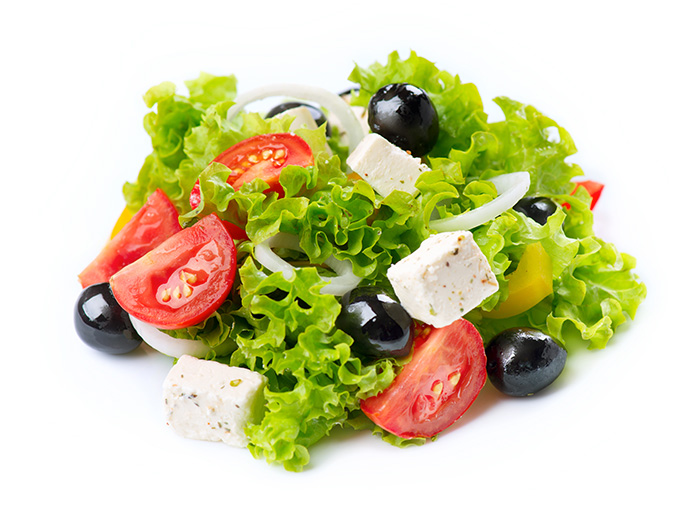 Freshly tossed salad with tomatoes and olives